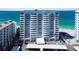 Beautiful exterior view of the beachfront condo building with light blue trim and stunning ocean views at 1750 Benjamin Franklin Dr # 11G, Sarasota, FL 34236