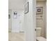 Hallway and adjoining bathroom feature light walls and tile floors at 1750 Benjamin Franklin Dr # 11G, Sarasota, FL 34236