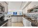 Modern kitchen overlooking the living area and ocean view, featuring granite counters and stainless appliances at 1750 Benjamin Franklin Dr # 11G, Sarasota, FL 34236