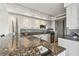 Well-equipped kitchen with granite countertops, tile backsplash, and modern appliances, offering both style and functionality at 1750 Benjamin Franklin Dr # 11G, Sarasota, FL 34236