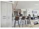 Modern kitchen featuring granite countertops, stylish bar stools, and stainless steel appliances at 1750 Benjamin Franklin Dr # 11G, Sarasota, FL 34236