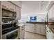 Well-lit kitchen with granite countertops, updated cabinets, stainless appliances, and an open layout at 1750 Benjamin Franklin Dr # 11G, Sarasota, FL 34236