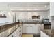 Bright and modern kitchen with stylish cabinets, granite countertops, and stainless steel appliances, designed for convenience at 1750 Benjamin Franklin Dr # 11G, Sarasota, FL 34236