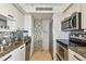 Efficient kitchen layout with updated appliances, granite countertops, and mosaic backsplash, making meal preparation enjoyable at 1750 Benjamin Franklin Dr # 11G, Sarasota, FL 34236