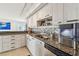 This stunning kitchen features granite countertops, stainless steel appliances, and stylish cabinetry at 1750 Benjamin Franklin Dr # 11G, Sarasota, FL 34236