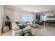 Open living room with stylish seating, modern lighting, and a calming blue color palette at 1750 Benjamin Franklin Dr # 11G, Sarasota, FL 34236