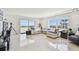 Bright living room with marble floors, modern furnishings, and gorgeous water view at 1750 Benjamin Franklin Dr # 11G, Sarasota, FL 34236