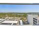 A wide view of ocean, coast and trees can be seen from the window at 1750 Benjamin Franklin Dr # 11G, Sarasota, FL 34236