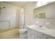 Bathroom with neutral wallpaper and white fixtures, including a tub at 2286 Norwegian Dr # 66, Clearwater, FL 33763