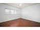 A bright bedroom with laminate wood flooring and a window at 2286 Norwegian Dr # 66, Clearwater, FL 33763