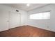 A bedroom featuring laminate wood flooring, a window, and closet at 2286 Norwegian Dr # 66, Clearwater, FL 33763