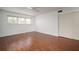 A bedroom featuring laminate wood flooring, a ceiling fan, and a window at 2286 Norwegian Dr # 66, Clearwater, FL 33763