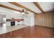 An eat-in kitchen featuring tile flooring, beams in the ceiling, and white appliances at 2286 Norwegian Dr # 66, Clearwater, FL 33763