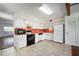 A kitchen with white cabinets and appliances, and an orange backsplash at 2286 Norwegian Dr # 66, Clearwater, FL 33763