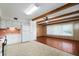 An eat-in kitchen with plank flooring, beams in the ceiling, and white appliances at 2286 Norwegian Dr # 66, Clearwater, FL 33763