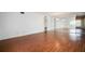 A bright living room with laminate flooring, a mirrored wall, and a glimpse of the kitchen at 2286 Norwegian Dr # 66, Clearwater, FL 33763