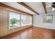 Bright living space showcasing laminate floors, exposed ceiling beams, and ample natural light at 2286 Norwegian Dr # 66, Clearwater, FL 33763
