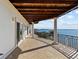 Spacious balcony with waterfront views and a wood ceiling covering at 2402 Baywood W Dr, Dunedin, FL 34698