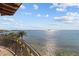 Enjoy breathtaking waterfront views from this home's private balcony, overlooking a tranquil bay and blue sky at 2402 Baywood W Dr, Dunedin, FL 34698