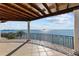 Stunning waterfront view from the home's expansive balcony with iron railing at 2402 Baywood W Dr, Dunedin, FL 34698