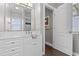 Bathroom vanity with white cabinets, quartz counters and view to the shower at 2402 Baywood W Dr, Dunedin, FL 34698