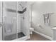Bright bathroom featuring a glass shower with white tile surround and gray accents at 2402 Baywood W Dr, Dunedin, FL 34698