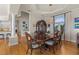Formal dining room with a chandelier, a large window, and access to other living areas at 2402 Baywood W Dr, Dunedin, FL 34698