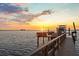 Private boat dock with a lift, providing convenient access to the water and stunning sunset views at 2402 Baywood W Dr, Dunedin, FL 34698