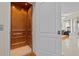 Interior view of the home's wood-paneled elevator with adjacent view of a living room at 2402 Baywood W Dr, Dunedin, FL 34698
