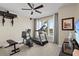 Bright exercise room with gym equipment and large windows offering a pleasant view at 2402 Baywood W Dr, Dunedin, FL 34698