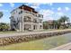 A luxury home's exterior view showcases its coastal architecture, with private dock and a swimming pool at 2402 Baywood W Dr, Dunedin, FL 34698