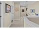 Upstairs hallway with neutral tones, artwork, and access to the bedrooms at 2402 Baywood W Dr, Dunedin, FL 34698