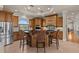Spacious kitchen features custom wood cabinetry, stainless steel appliances, and a large central island with barstool seating at 2402 Baywood W Dr, Dunedin, FL 34698