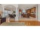 Open-concept kitchen with granite countertops, wooden cabinets, and a spacious dining area with tiled floors at 2402 Baywood W Dr, Dunedin, FL 34698