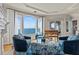 Bright living room with large windows, a piano, and comfortable seating overlooking the waterfront at 2402 Baywood W Dr, Dunedin, FL 34698