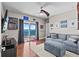 Relax in this coastal-themed living room with comfortable seating and direct access to the water at 2402 Baywood W Dr, Dunedin, FL 34698