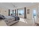 This main bedroom features bay window with water views, a sitting area, and a ceiling fan at 2402 Baywood W Dr, Dunedin, FL 34698