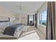 This expansive main bedroom is bathed in natural light and has coastal views at 2402 Baywood W Dr, Dunedin, FL 34698