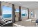 Enjoy panoramic ocean views from this main bedroom with a comfy reading nook and ensuite bath at 2402 Baywood W Dr, Dunedin, FL 34698