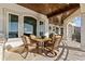 A covered patio provides comfortable seating with views of the water and a wooden ceiling at 2402 Baywood W Dr, Dunedin, FL 34698