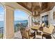 This patio offers outdoor seating, a fire table, and beautiful waterfront views with boat access at 2402 Baywood W Dr, Dunedin, FL 34698
