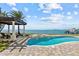 Enjoy the waterfront from the pool and adjoining spa, located near the pergola and dock at 2402 Baywood W Dr, Dunedin, FL 34698