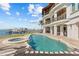 Outdoor pool with hot tub, dock and beautiful view of the water at 2402 Baywood W Dr, Dunedin, FL 34698