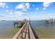 A private dock extends into the water, providing a scenic pathway to the bay at 2402 Baywood W Dr, Dunedin, FL 34698