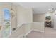 A well-lit staircase features an elegant chandelier and views of the neighborhood at 2402 Baywood W Dr, Dunedin, FL 34698