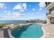The beautiful swimming pool features an attached spa and patio with beautiful views at 2402 Baywood W Dr, Dunedin, FL 34698