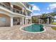 This beautiful swimming pool features an attached spa and patio with bar, overlooking the water at 2402 Baywood W Dr, Dunedin, FL 34698