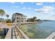 A luxury waterfront home is showcased with a private dock at 2402 Baywood W Dr, Dunedin, FL 34698