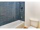 Modern bathroom features a shower with blue tile, a toilet and vanity at 2444 Jacobs St, Port Charlotte, FL 33953