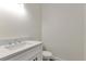 Well-lit half bathroom featuring white vanity with quartz countertop and modern fixtures at 2444 Jacobs St, Port Charlotte, FL 33953